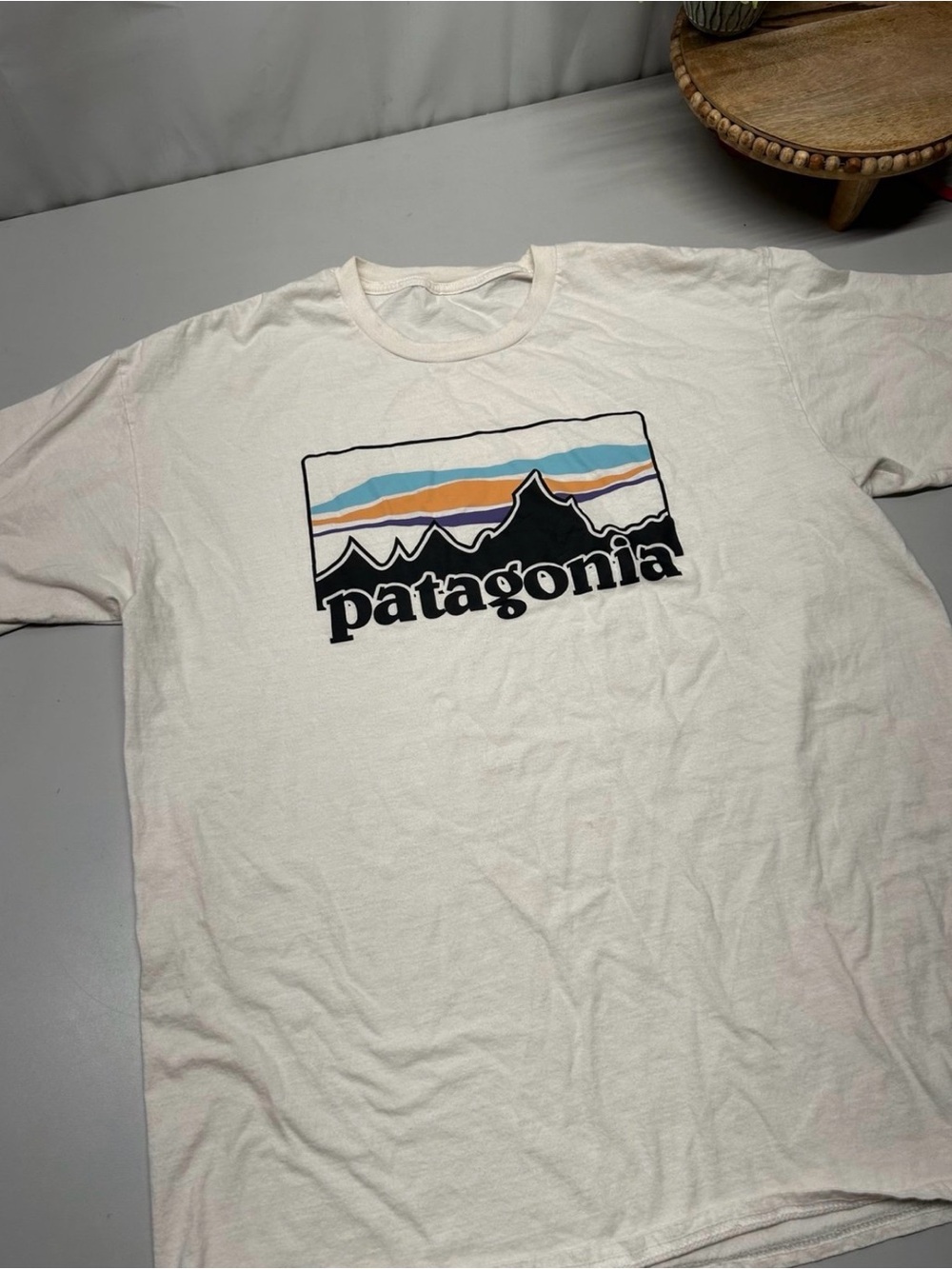 Patagonia Off-White Graphic Tee with Blue and Orange Stripe